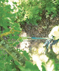 Arborist using Rope Sniper Pro Arborist Tool for effortless rope placement and laser sharp precision in a tree rigging job