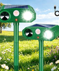 Solar Powered Outdoor Animal Deterrent With Motion Activated Ultrasonic Alerts And LED Strobe Lights Two Pack on grass