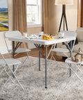 34-Inch Square Folding Table With Carrying Handle in a living room with four chairs, set for indoor use