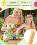 Mother and daughter using 15 Piece Kids Beach Sand Toys And Garden Tool Set with solid wood handle in garden.
