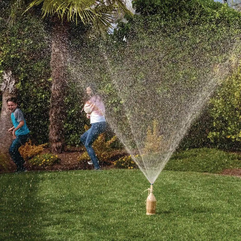 Extreme Geyser Tube Science Kit For Kids With Mentos And Soda Lab Experiment creating a soda eruption in a yard.