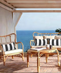 Outdoor Indoor Lumbar Pillows Pack Of 2 Cushions For Patio And Home Sofa Use Water Repellent Fluffy All Weather Cushions 12x20 Inch Cabana Black showcased on wicker patio furniture with ocean view.