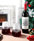 Stemless Wine Glass Set Of 4 Hand Made 16oz Crystal Red And White Wine Glasses For Everyday Use next to wine bottle and Christmas decor