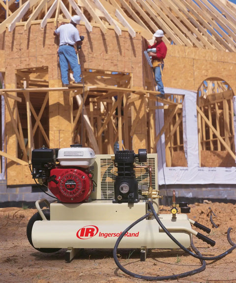 135 Psi 5.5 Hp Gas Powered Air Compressor Runs Smooth With Honda Engine And Cast Iron Construction Featuring Wheelbarrow Design For Easy Rolling Plus Dual Quick Disconnects For Tough Jobs All Day Long Without Breaking A Sweat, shown at a construction site