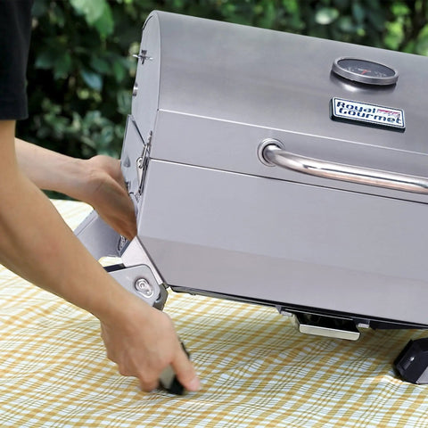 Stainless Steel Portable Tabletop Gas Grill With 10000 BTU Power, 285 Square Inches Of Cooking Space being set up on table