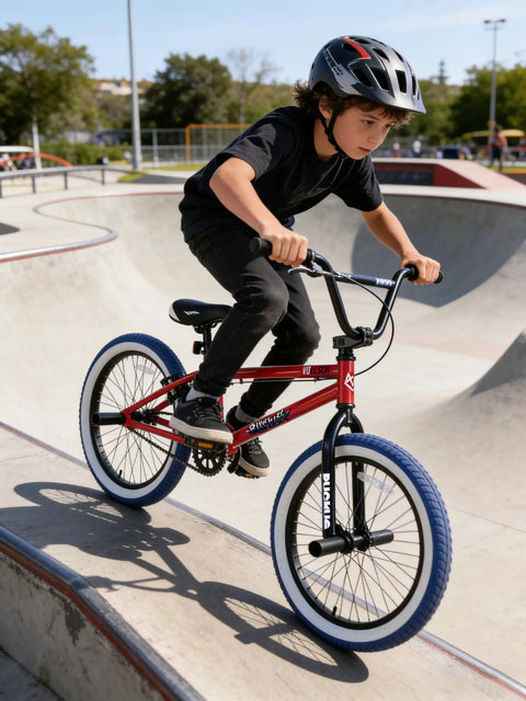 Child riding Freestyle 20 Inch BMX Bike For Beginners Kids 8 To 15 Red Frame With Blue Tires Kid Friendly in skatepark