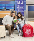 Family with suitcases at airport next to Gate Check Travel Bag For Compact Fold Strollers With Built In AirTag Holder Red.