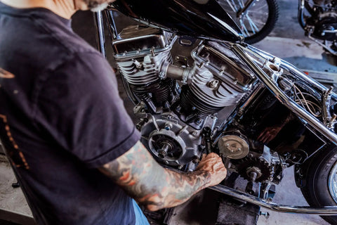 Mechanic using 8-In-1 SAE Ratcheting Wrench Set In Two Pieces With Hollow Sockets And Double Box End Design on motorcycle engine