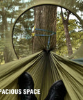 View from inside Mosquito Net Camping Hammock With Lightweight Parachute Nylon, feet visible, setup between trees