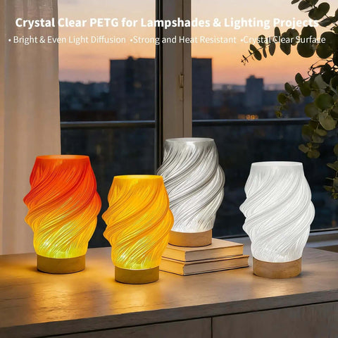 Crystal Clear PETG Filament 1.75mm 1kg for 3D printing in colorful lampshades on a window sill with city view.