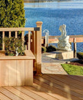 Wooden deck with railing and planters near a lake, featuring heavy duty pergola brackets kit for 4x4 wood posts with included screws.