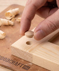 Placing 120Pcs Wood Screw Hole Plugs With Top for Wooden Furniture on wooden surface, showing natural grain finish and easy install