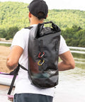 ExoDry 30L Large Drybag With Roll Top Closure Waterproof 500D PVC on man kayaking by river, showing backpack style straps, black