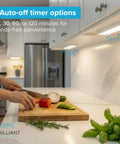 Warm White Wireless LED Light Bar 8.5 Inch for under cabinets with remote dimmer, illuminating a kitchen while cutting vegetables