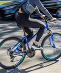 Cyclist riding All-Terrain Go-To Hybrid Bike With 700c Wheels 21-Speed Gearing Aluminum Frame Suspension Fork on city street