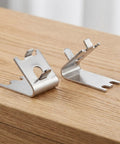 Heavy Duty Stainless Steel Freezer Shelf Clips Set on wooden surface, showing angled design for secure shelving support.