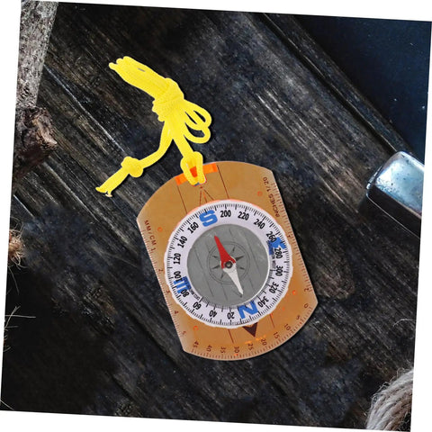 Orienteering Compass Ruler And Pointer For Hiking And Camping, acrylic tool with yellow lanyard on wood surface