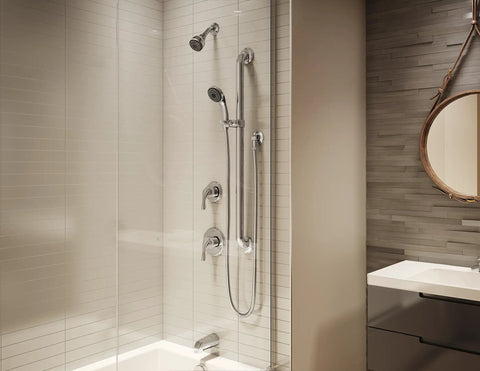 Modern bathroom with Origins Tub and Shower Trim with Diverter and ADA Metal Lever Handle, polished chrome finish visible.