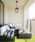 Straight Up Farmhouse Outdoor Pendant Light With Clear Glass Shade And Rust Proof Metal Frame Killing It As A Heavy Duty Hanging Lantern Top Shelf Pick For Porches Entryways And Gazebos In Sleek Matte Black illuminating a balcony seating area.