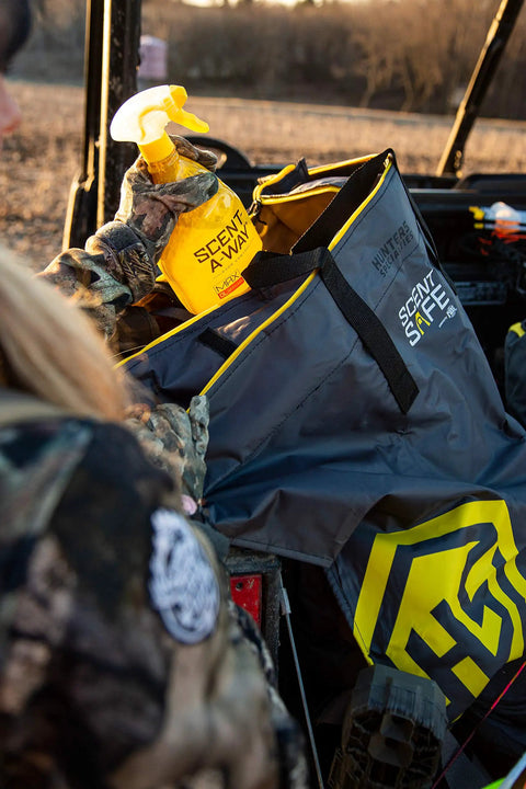 Hunter using Scent Safe Deluxe Travel Scent Bag For Hunting Gear And Clothing Keeps Your Scent Hidden And Your Gear Scent Free.