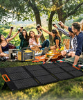Top Shelf Solar Generator Bundle 200 Watt Panel Hooked Up To 1000 Watt Power Station used by friends outdoors at a picnic.