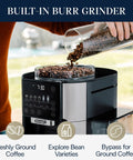 Person adding coffee beans to True Brew Drip Coffee Maker With Built In Grinder And Single Serve Function Brew 8 Oz To 24 Oz Hot Or Iced Coffee Stainless Steel CAM51025MB For Everyday Home Use.