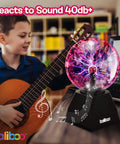 Child playing guitar next to 6 Inch Plasma Ball Light With Touch And Sound Activation Lightning Globe For Home Desk Fun Lit Interactive Science Toy 12V Power Adapter Plug Gift For Teens And Kids