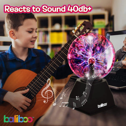 Child playing guitar next to 6 Inch Plasma Ball Light With Touch And Sound Activation Lightning Globe For Home Desk Fun Lit Interactive Science Toy 12V Power Adapter Plug Gift For Teens And Kids