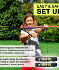 Woman setting up BananaLama XL Slackline With TreeWear Do It All Slack Line Kit Eighty Two Feet By One Point Five Inch