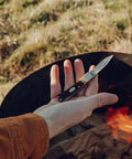 Person holding Bearhead Lockback Pocket Knife With A 2.2 Inch High Carbon Stainless Steel Blade And Sawcut Handle outdoors