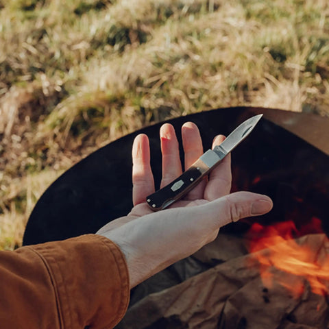 Person holding Bearhead Lockback Pocket Knife With A 2.2 Inch High Carbon Stainless Steel Blade And Sawcut Handle outdoors
