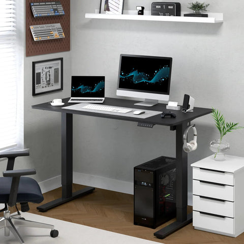 FLEXISPOT Electric Standing Desk With 40x24 Seamless One-Piece Black Desktop featuring dual monitors and laptop in home office setting.
