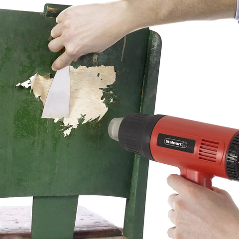 Dual Temperature 1500W Heat Gun Workhorse With 575 To 932 Degrees Fahrenheit Settings in use for paint removal on chair