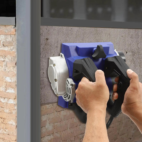 Using the Heavy Workhorse 1300W Handheld Wall Planer against a wall for efficient paint stripping.