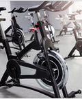 Stationary bikes in gym with black frames; possible use of M16 Pull Pin Spring Knob For Home Fitness Equipment Height Adjustment Replacement Parts Black Orange 2 Pack Durable Steel And ABS Build With Built In Spring Handle For Safe Easy Install.
