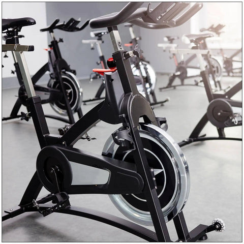 Stationary bikes in gym with black frames; possible use of M16 Pull Pin Spring Knob For Home Fitness Equipment Height Adjustment Replacement Parts Black Orange 2 Pack Durable Steel And ABS Build With Built In Spring Handle For Safe Easy Install.
