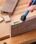 Applying glue to wood joint using Silicone Glue Brush Set For Beadlock Tenons Ribbed Tenon Shaped Applicators on a workbench