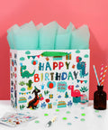 13 Inch White Gift Bag Set With Greeting Card And Tissue Paper, Green Dino Design, Happy Birthday Theme, on pink background