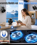 Rechargeable Magnetic Travel Fan With 12000mAh Battery And Power Bank Mode mounted on metal surface, cooling a woman reading.