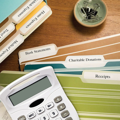 Top Shelf File Folder Labels Featuring Trueblock Coverage And Relentless Permanent Adhesive Engineered For Laser And Inkjet Printers Bulk white sheets arranged with a calculator.