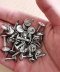 Badass 100 Pack Number 8 X Half Inch 410 Stainless Wafer Head Phillips Self Drilling Sheet Metal Tek Screws in hand.