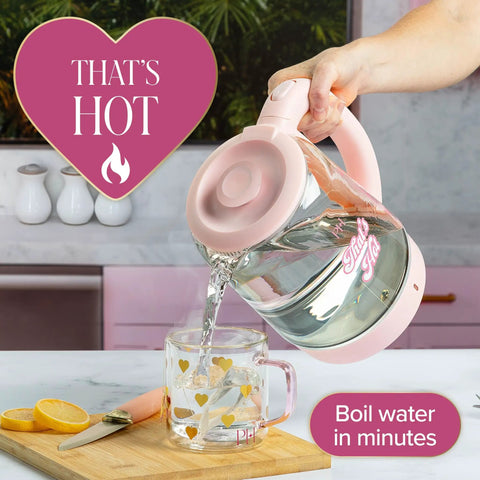 Person pouring water from a Pink Glass Electric Kettle 1.8 Liter With 1100 Watt Fast Boil Auto Shut Off Boil Dry Protection into a mug