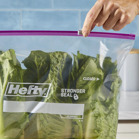 Jumbo 2.5 Gallon Storage Bags With Secure Zip And Click Closure Writable Label holding green lettuce leaves.