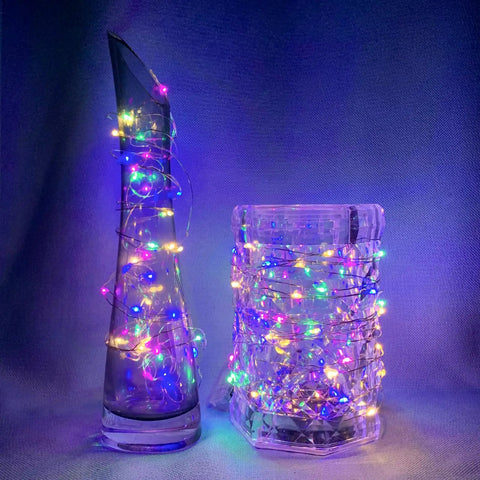 8 Pack 7Ft Fairy Lights With 20 LED Twinkle String Lights Battery Operated wrapped around colorful glass vases.