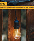 Outdoor 24 Pack Dimmable Shatterproof S14 LED Replacement String Light Bulb hanging on wooden post, Edison style, warm glow