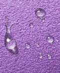 Close-up of water droplets on purple foam sander block from 110 Piece Sandpaper Variety Pack Wet Dry Grit 80 To 3000