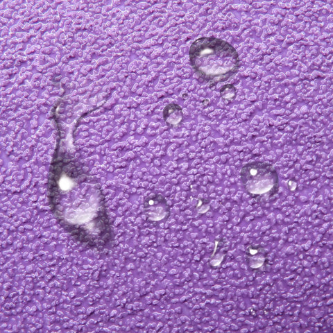 Close-up of water droplets on purple foam sander block from 110 Piece Sandpaper Variety Pack Wet Dry Grit 80 To 3000