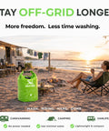 Off Grid Portable Washing Machine For Camping And RVs beside a camper at sunset, green, high capacity manual clothes washer with plunger.