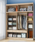 Wooden closet organizer with shelves, hanging rod, and storage boxes; clothes, towels, and shoes displayed neatly in a bedroom setting.