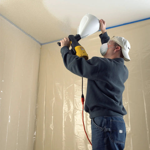 Person using Power Tex Texture Sprayer For Walls And Ceilings With Three Nozzles, Quick Lock N Go, Durable Yellow Finish on ceiling